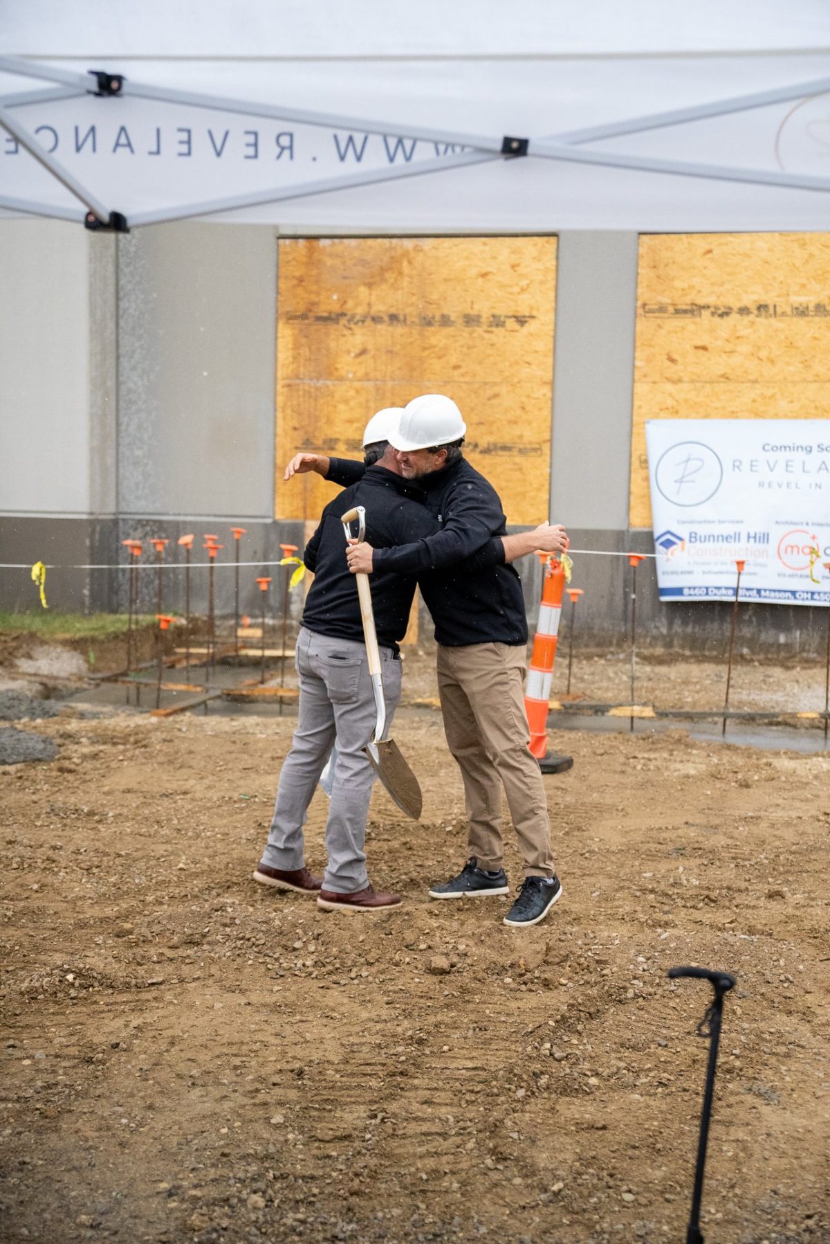 Founders embrace at the Revelance groundbreaking