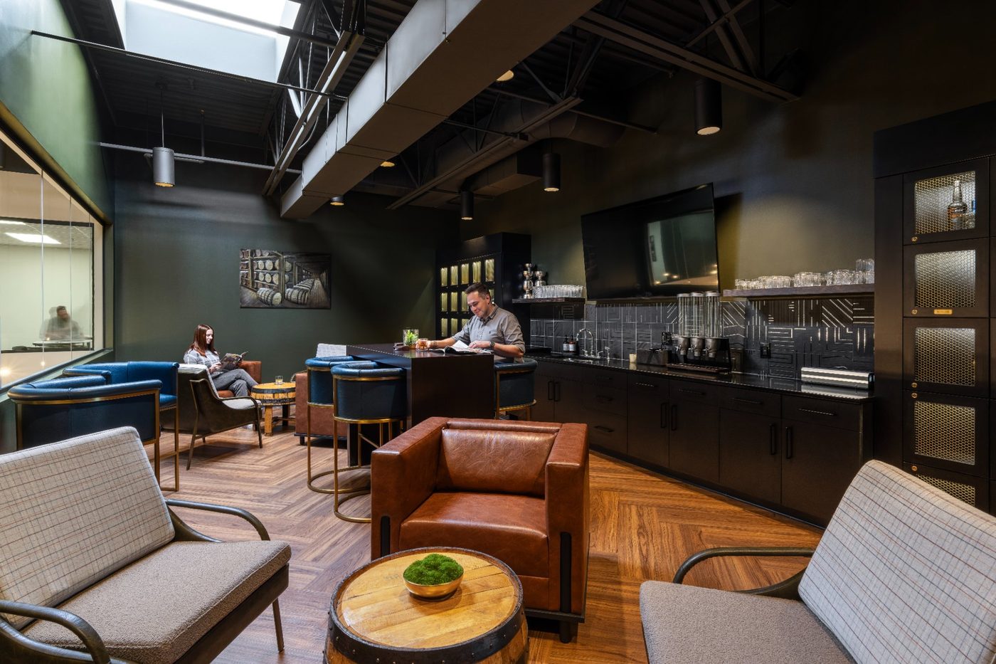 Guests relaxing at the bar in the C-Suite private lounge at Revelance Mason Ohio
