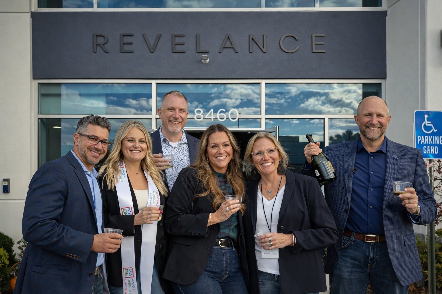 Revelance team and partners celebrating after the grand opening ribbon cutting, 8460 Duke Blvd Mason Ohio