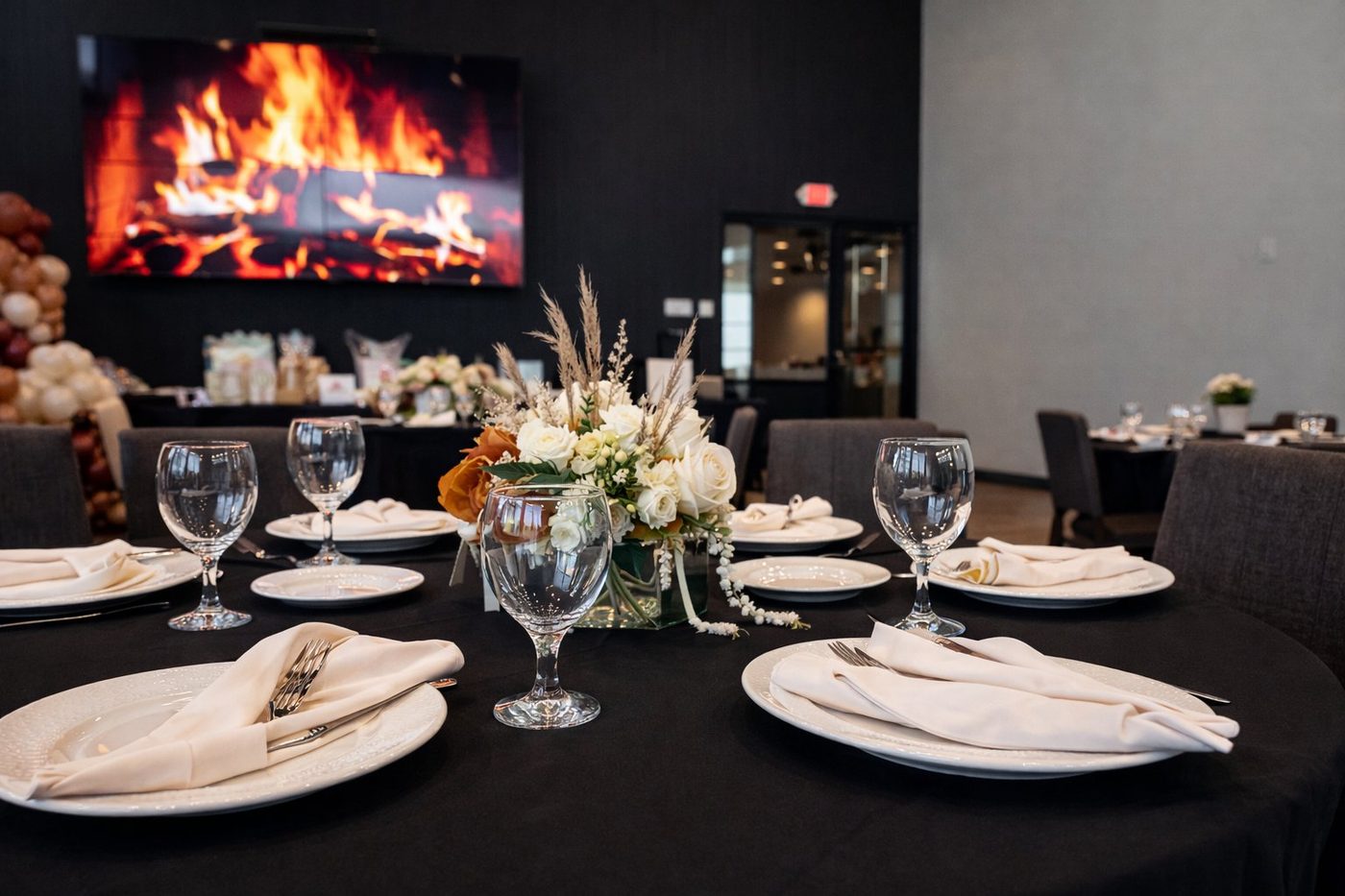 Revel Room table setting with fireplace video wall