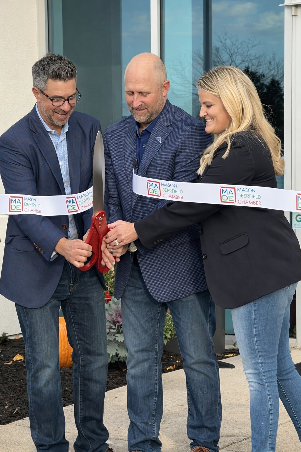 Patrick Malloy, Joe Clark, and MADE Chamber representative cutting the ribbon at Revelance grand opening