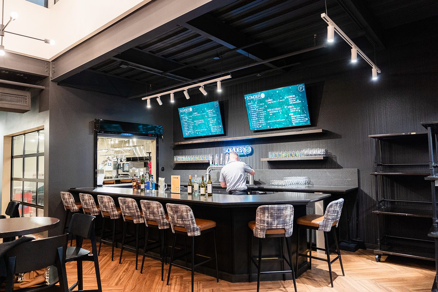 The Taphouse full bar at Revelance with Sonder Brewing taps and menu screens