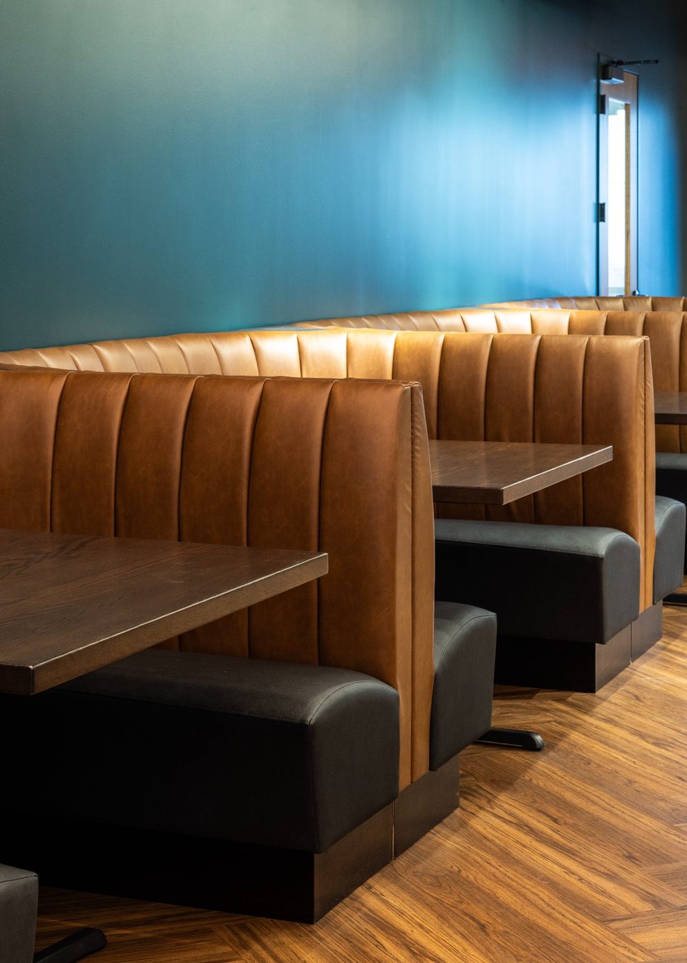 Leather banquette seating at The Taphouse Revelance